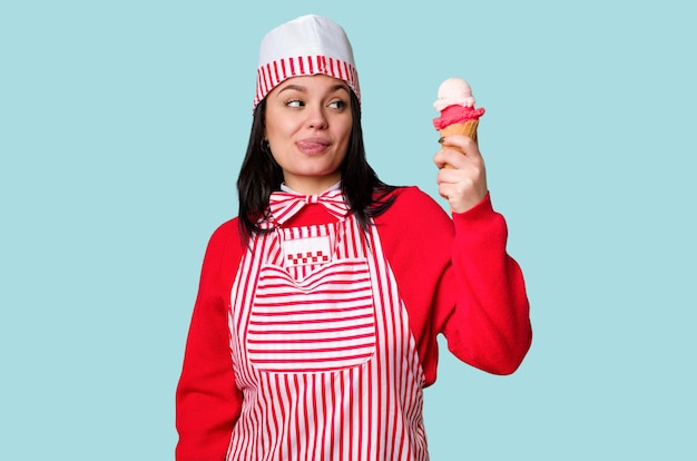 A young ice cream vendor in vintage attire holds a sweet cone smiling happily It's a perfect summer