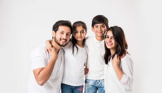 Young Indian asian family sitting isolated over white background. selective focus