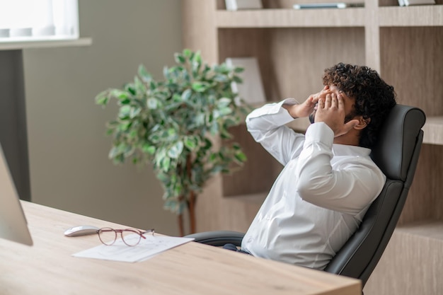 Young indian businessman looking tired