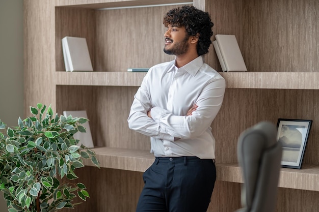 Young indian businessman sstanding with arms crossed