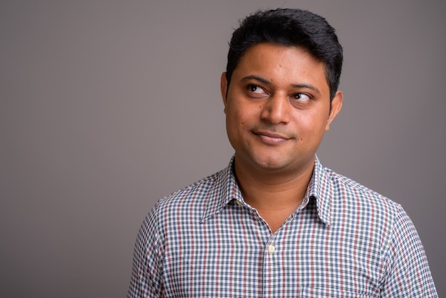 young Indian businessman wearing checkered shirt 