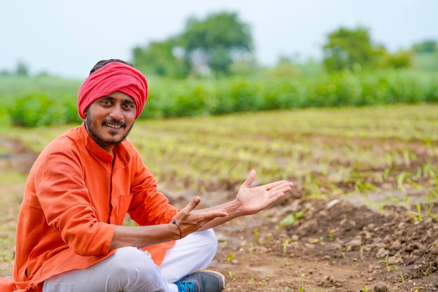 Young indian farmer at agriculture field.