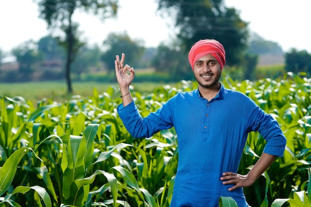 Young indian farmer at corn field