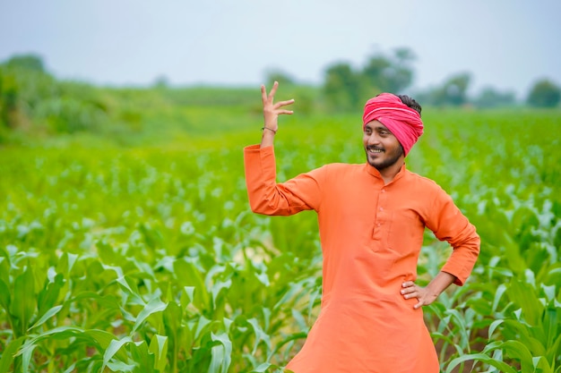 Young indian farmer at corn field.