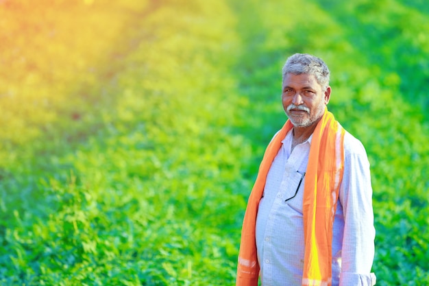 Young indian farmer at field