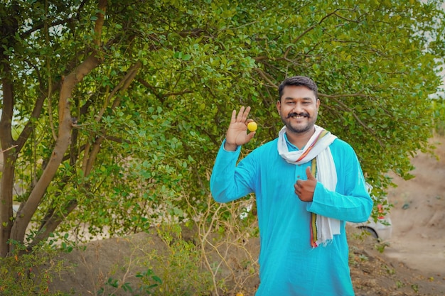 Young indian farmer at lemon field