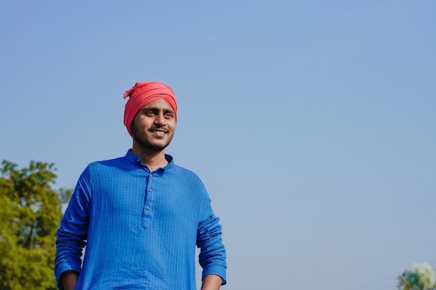 Young indian farmer at onion agriculture field