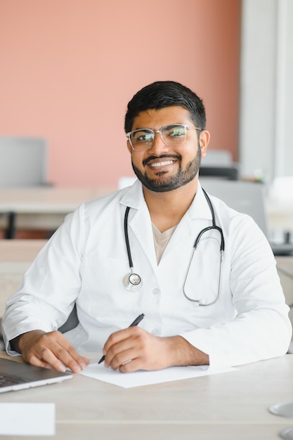 Young Indian male professional doctor wear white medical uniform with stethoscope