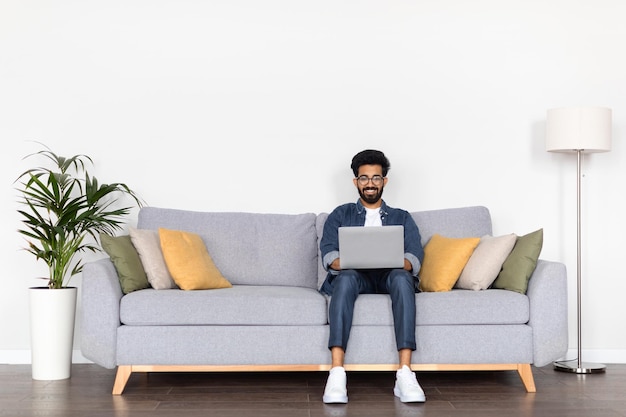 Young indian man engaged in online work at home