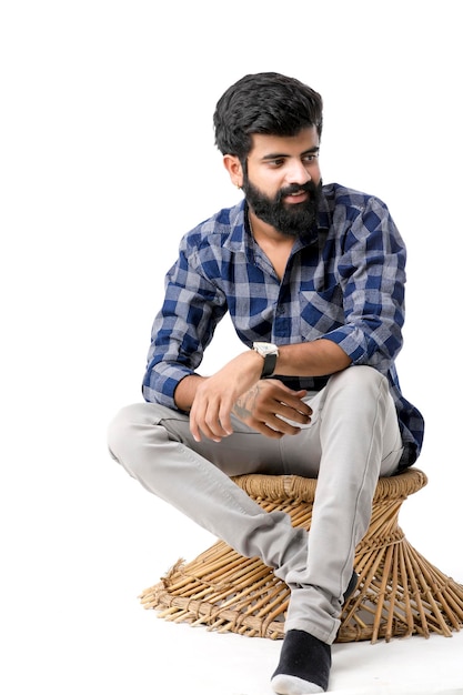 Young indian man giving expression over white background