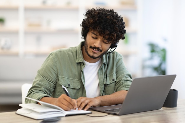 Young indian man having online training home interior