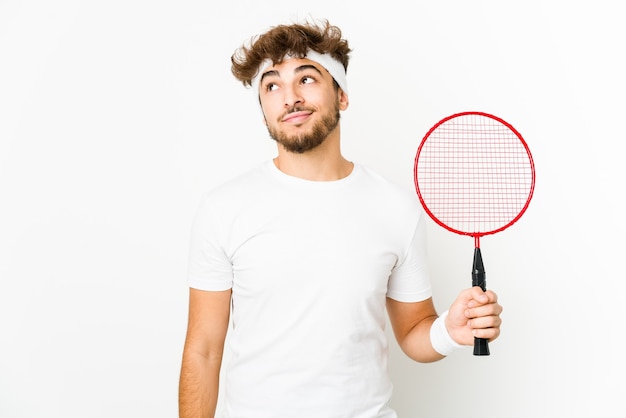 Photo young indian man playing badminton dreaming of achieving goals and purposes