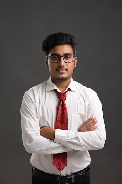 Young indian man showing expression on dark background.