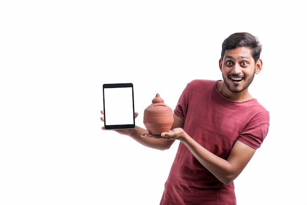 Young indian man showing tablet over white background.