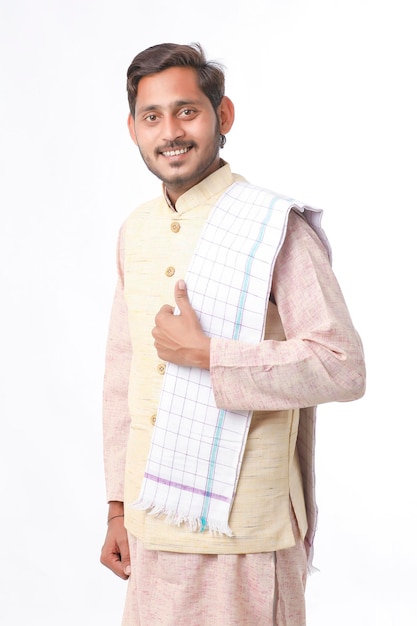 Young indian man in traditional wear and giving expression on white background.