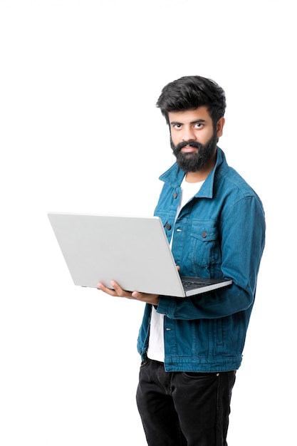 Young indian man using laptop on white background