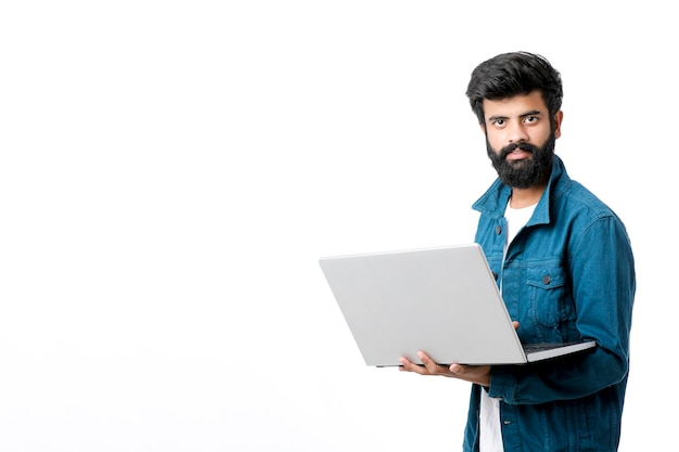 Young indian man using laptop on white background