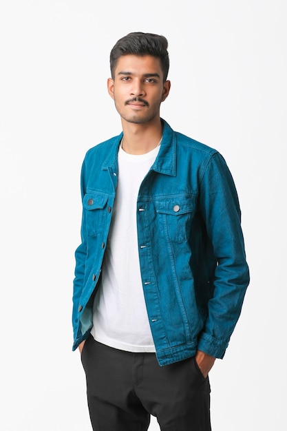 Young indian man wear jacket and giving expression over white background.