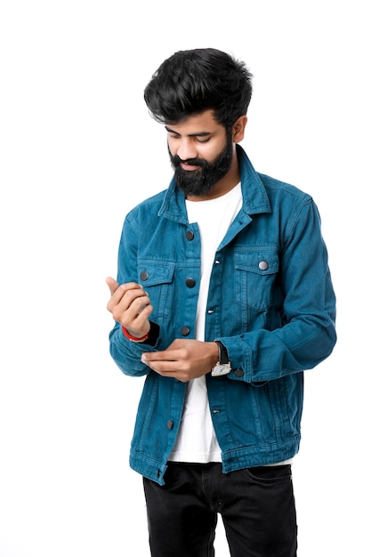 Young indian man wear jacket and giving expression over white background