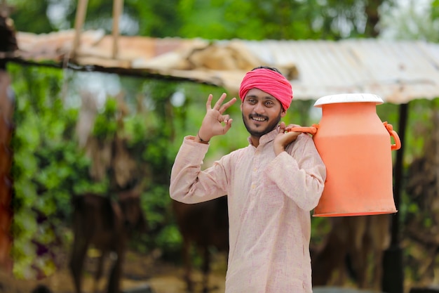 Young indian milk man at his farm