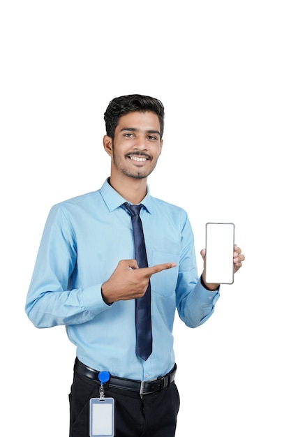 Young indian officer or student showing smartphone screen on white background.