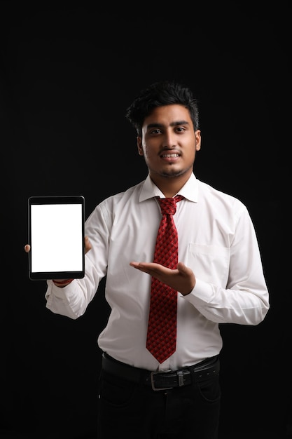 Young indian officer or student showing smartphone screen