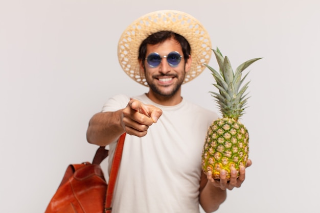 Young indian traveler man pointing or showing