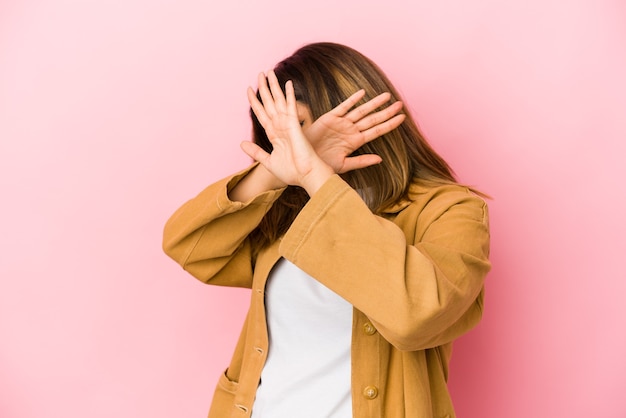 Young indian woman isolated on pink keeping two arms crossed, denial concept.