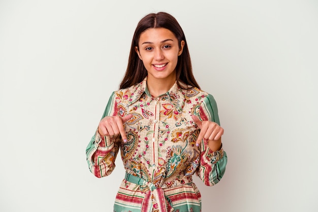 Young Indian woman isolated on white points down with fingers, positive feeling.