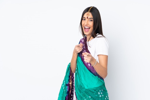 Young Indian woman isolated on white wall pointing to the front and smiling