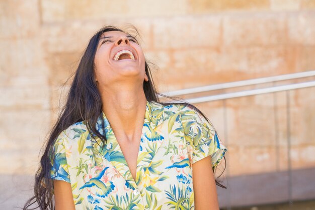 Young indian woman laughing in the street