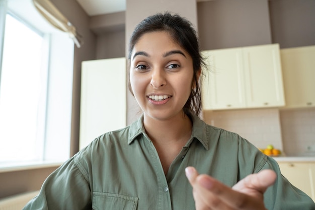 Photo young indian woman speaking to webcam during video call headshot