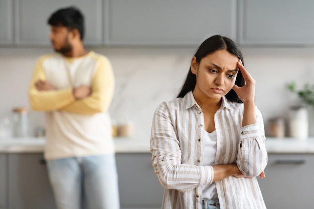 Young indian woman touching her head have fight with husband