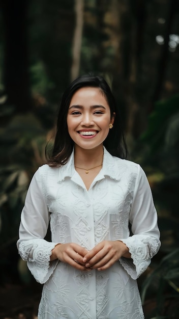 Photo a young indonesian woman with a happy successful expression wearing a white kebaya kartini39s day c