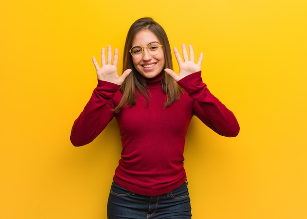 Young intellectual woman showing number ten