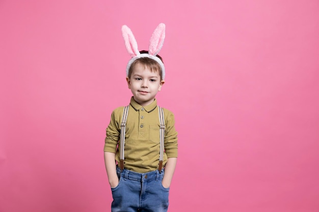 Photo young joyful child wearing cute bunny ears in front of camera