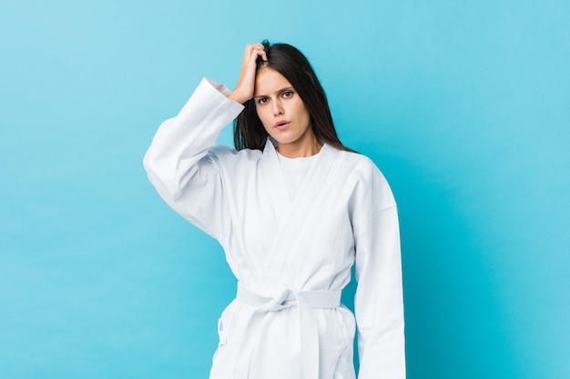 Young karate woman being shocked, she has remembered important meeting.