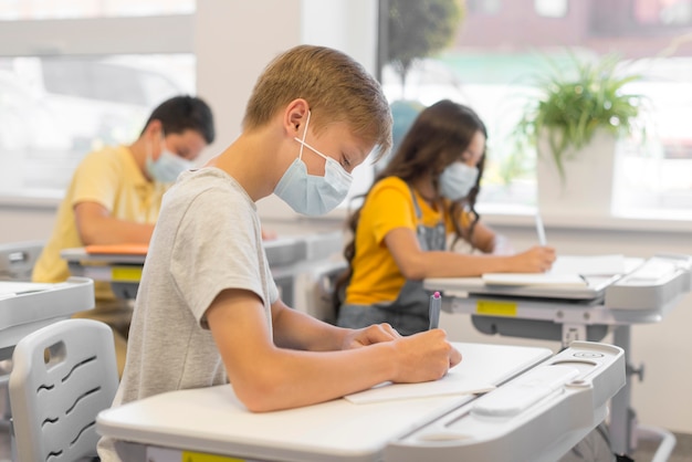 Young kids in class with masks