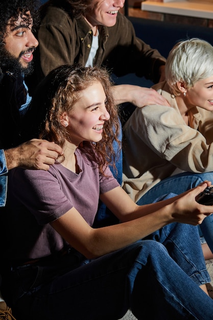 Young ladies playing game console at home at weekends in the evening, dressed casually, having leisure time. hobby, games, people lifestyle concept