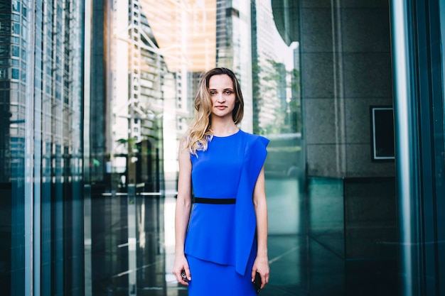 Young lady in blue apparel standing in city