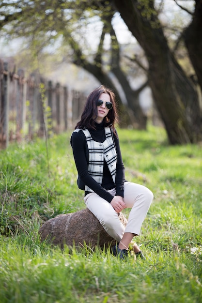 Young lady in cell jacket and black sunglasses