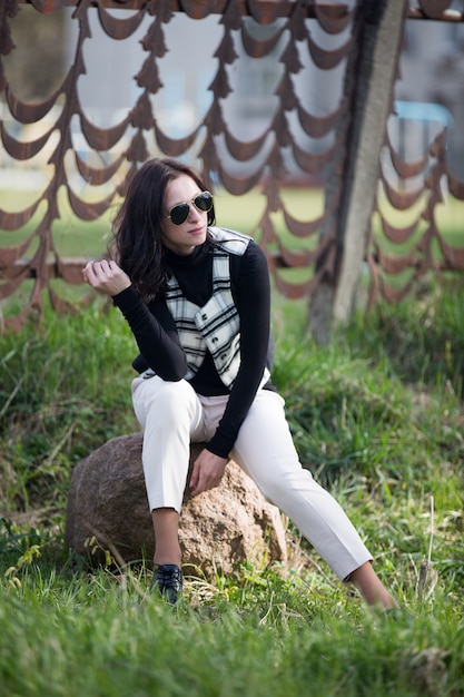 Young lady in cell jacket and black sunglasses