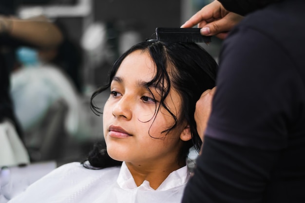 Young lady getting makeup and hair done in a professional spa or hair salon.