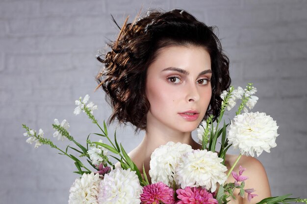 Young lady holding flowers in her hands