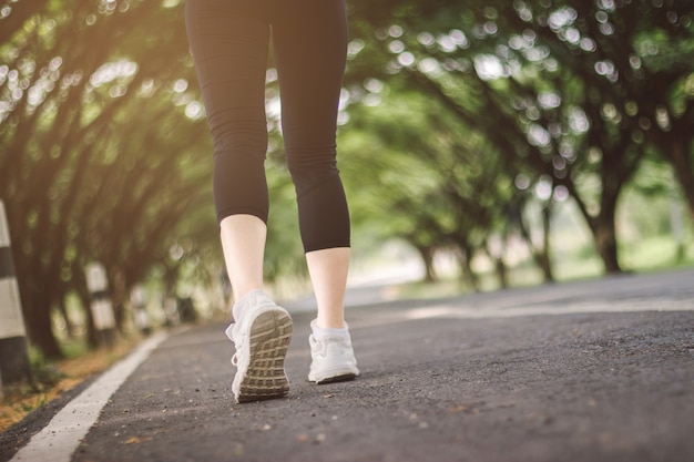 Young lady is running on the road