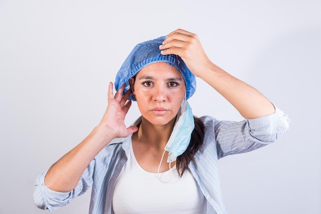 Young latin american doctor satisfied putting on her cap doctors investigating an infection