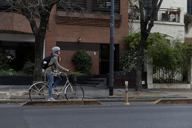 A young Latin American university student rides her vintage bicycle through the city