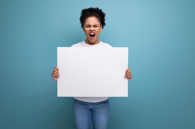 Young latin brunette female student presenting her study project on a white easel with mockup