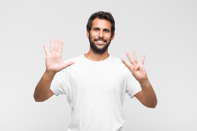 Young latin handsome man in t-shirt isolated