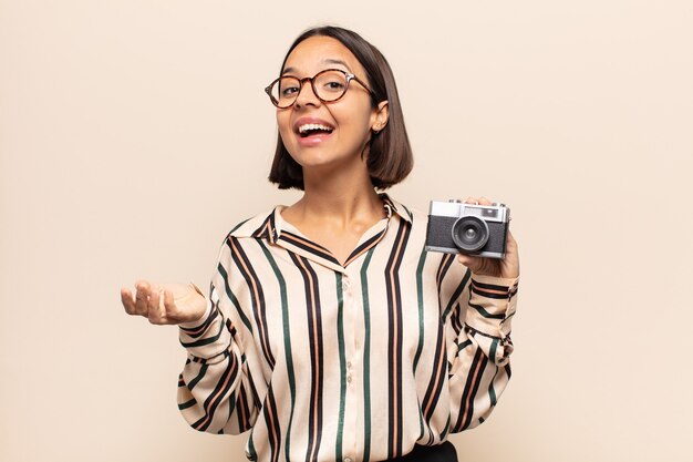 Young latin woman feeling extremely shocked and surprised, anxious and panicking, with a stressed and horrified look